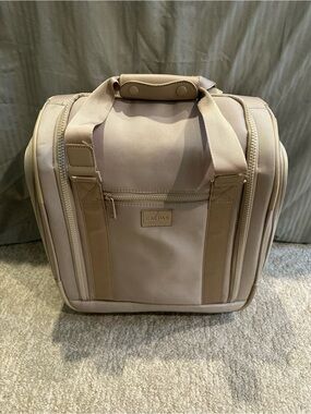 Calpak light pink under the seat rolling luggage